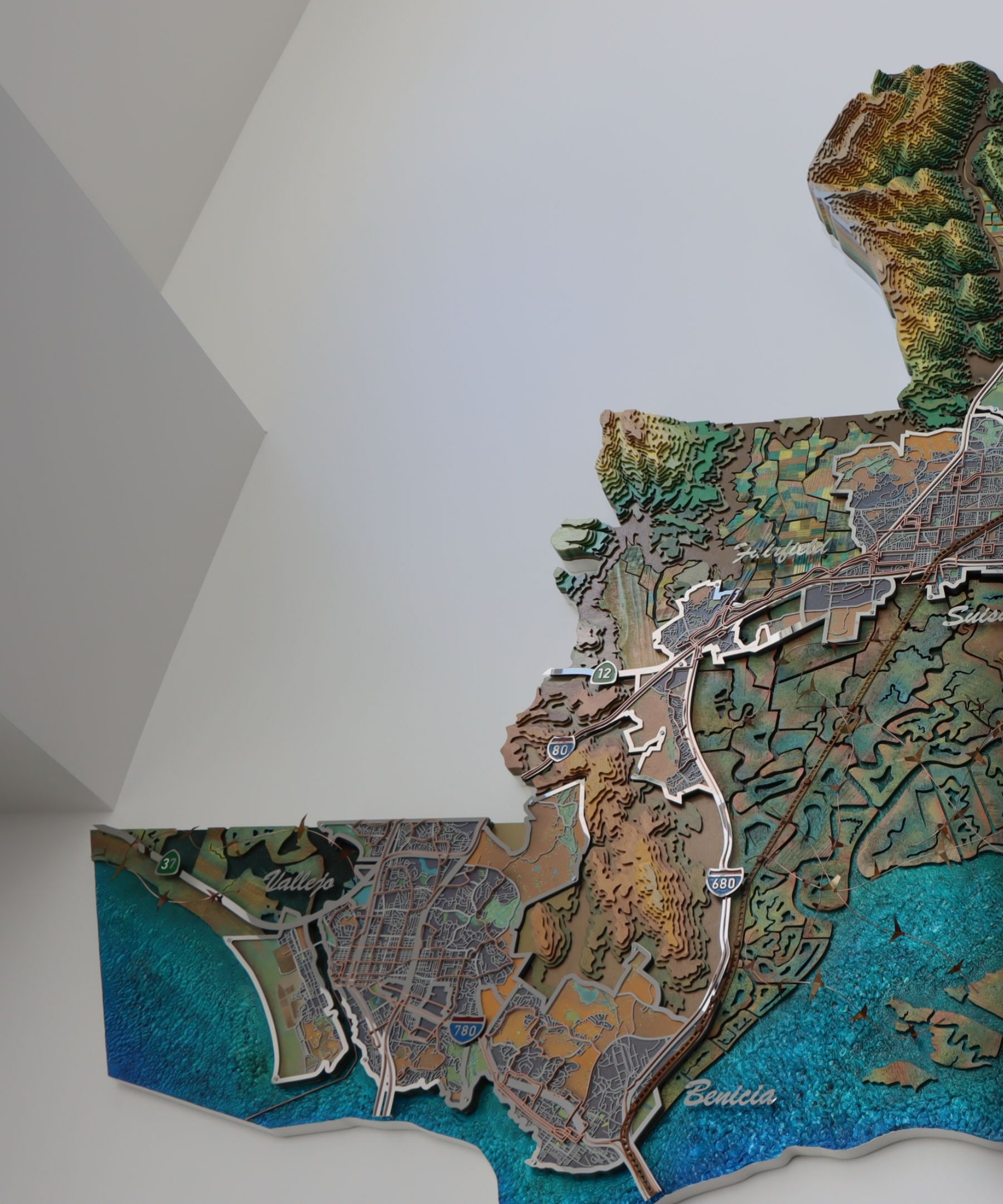 Wall-mounted relief map of Solano County in layered wood and metal