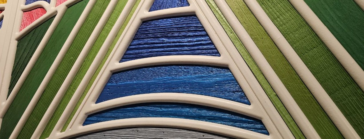 Painted blue and green wood slats within the white lattice