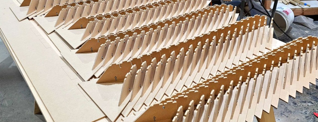 Rows of cut panel parts staged during fabrication
